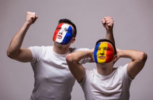 France vs Romania white background. Football fans of Romania and France national teams demonstrate emotions: Romanian lose, France win. football fans concept.